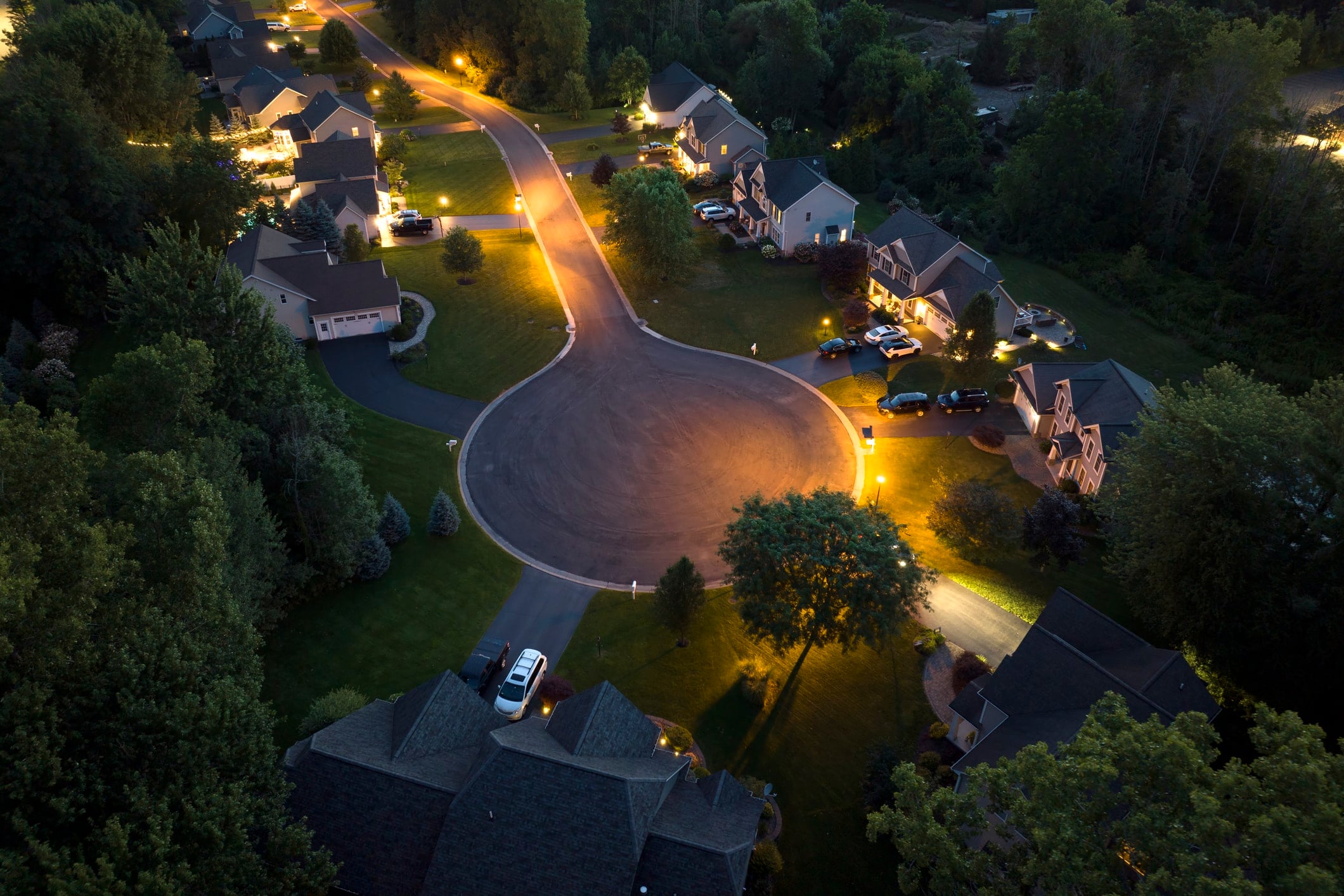 Aerial view of large private homes in Rochester, NY residential area at night. New family houses as example of real estate development in american suburbs.